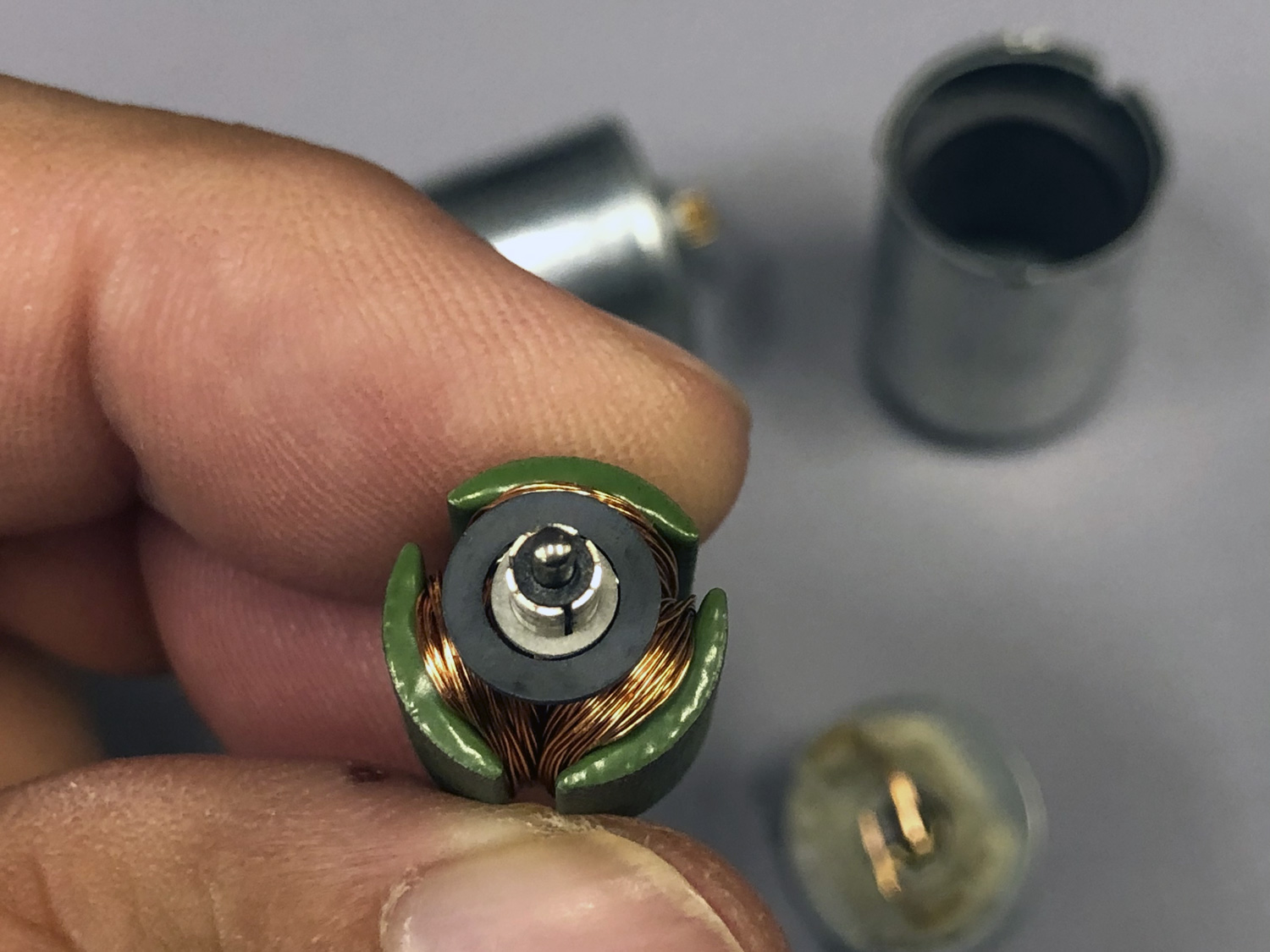 In this photo, note the commutator ring, which is split into three sections. As the brushes make contact, they switch the windings on sequentially.