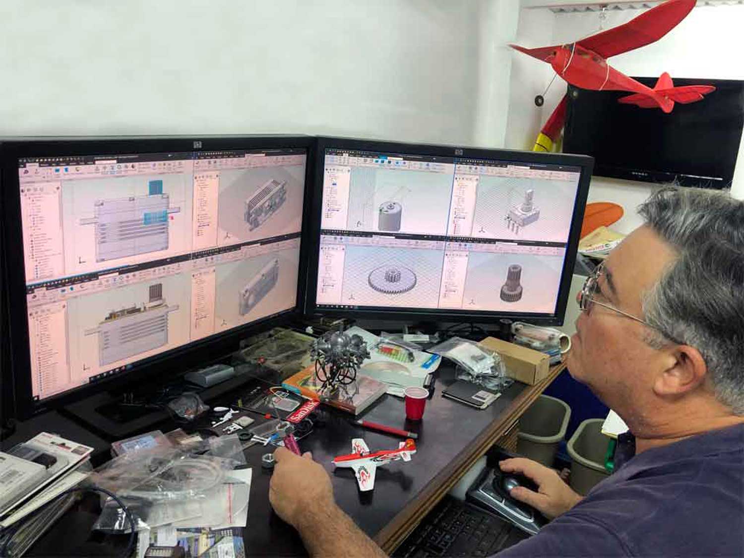 Engineer sits at a workstation designing a model type servo