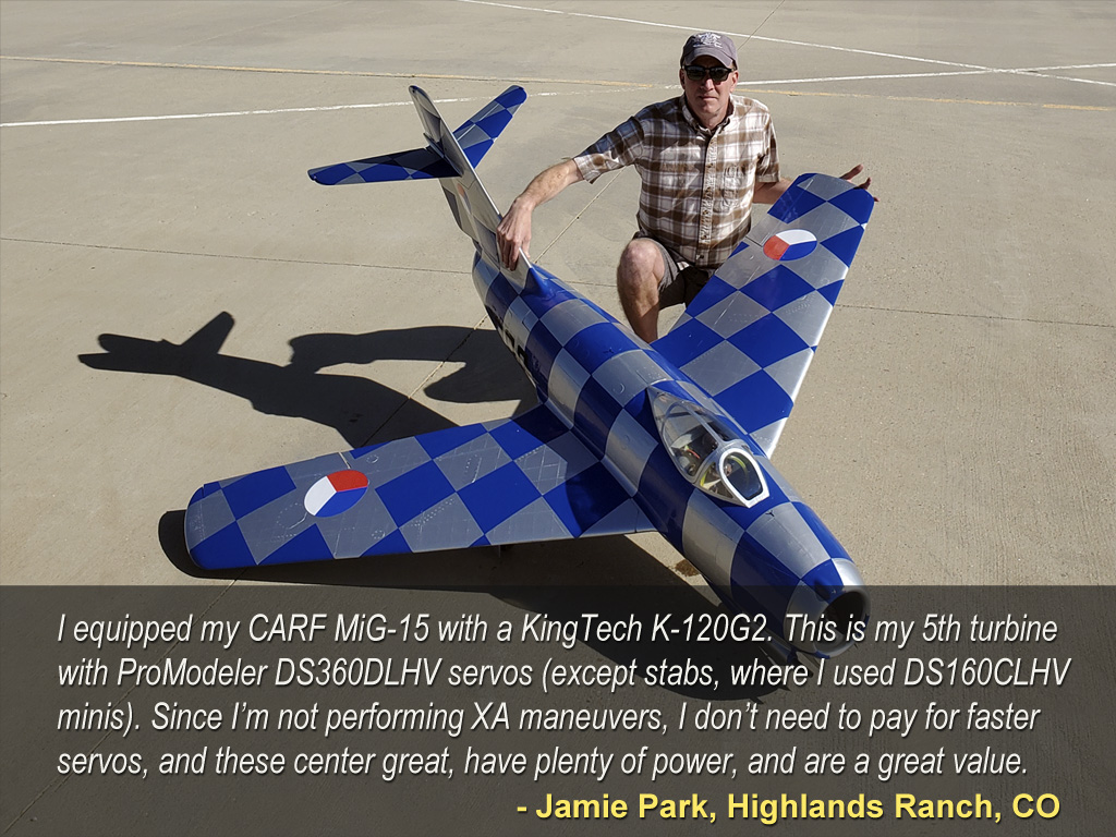 image showing large RC plane with its pilot kneeling behind it